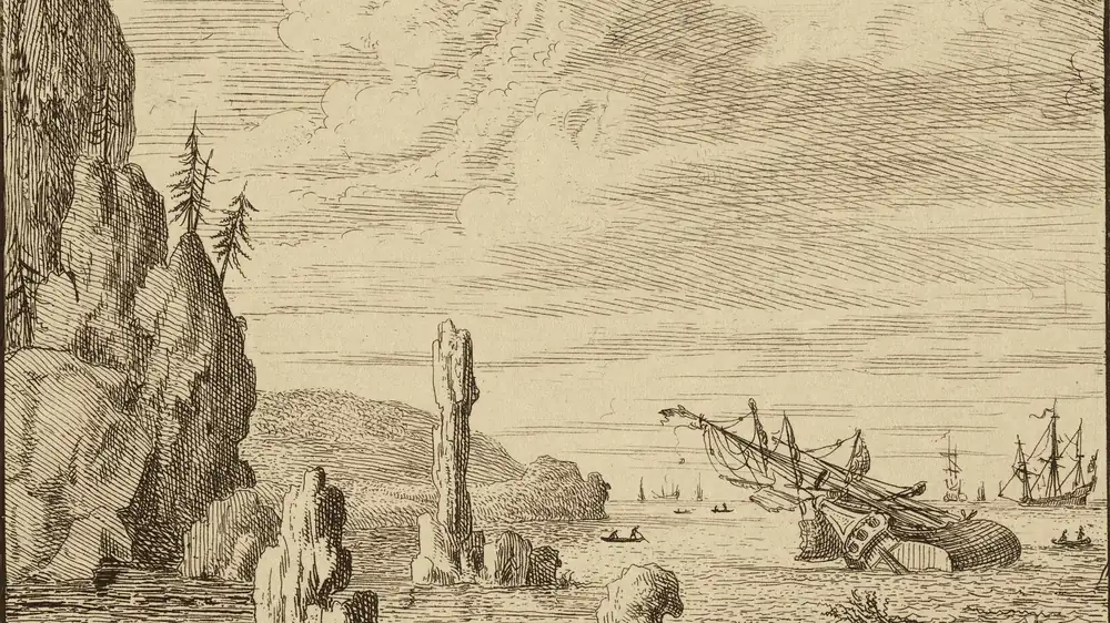 A wrecked ship on a reef in clear shallow water